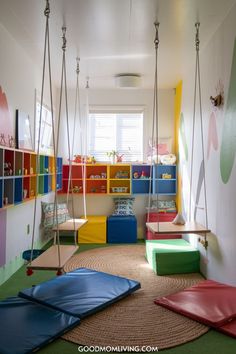 Bright and colorful children's playroom featuring swings, vibrant wall colors, and playful furniture, designed for creativity and fun. Rainbow Playroom