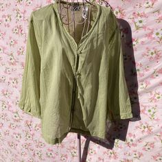 vintage y2k 100% cotton button up blouse. Soft sheer celery green material. Button front closure, v neckline with cute ruffle detail, and 3/4 length sleeves. Would fit best a L - XL, but please check the measurements to ensure a perfect fit for you. Tag size is an XL.   Here to help if you have any questions. Freshly laundered. 21.5 in chest 23.5 in length 11 in sleeve laid flat, please double where needed Green V-neck Shirt For Spring, Cottagecore V-neck Tops For Spring, Casual Light Green Long Sleeve Blouse, Green Spring Tops With Button Closure, Green Vintage V-neck Blouse, Cottagecore Spring Top With Buttons, Green Cotton Cottagecore Tops, Green Cottagecore Tops For Spring, Cottagecore Green Cotton Top