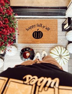 a door mat that says happy fall y'all with pumpkins and other decorations