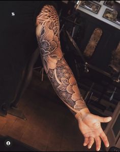 a man's arm with a flower tattoo on it