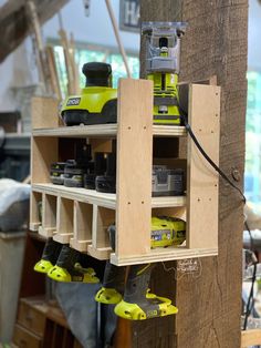 a work bench with some tools hanging from it's sides and two pairs of shoes on the shelf