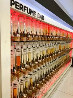 there are many different types of drinks on display in the store's glass case