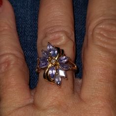 14k Yellow Gold Marquise Tanzanite Diamond Accent Cluster Ring. This Item Has A Composition Of 14k Gold Marked. The Center Gemstone Is 1x=Diamond. This Is Beautifully Accented With 10x=Tanzanite. The Item's Condition Is Estate:Good. This Item Has A Weight Of 3.2 Grams. We Would Consider This Piece To Be Vintage. This Ring Is Size 6. I Tried To Get A Picture Of The Gold Stamp On The Inside Of The Ring, I Couldn't Get A Clear One Fine Jewelry Tanzanite In Lavender Color, Purple 14k Stamped Ring, Lavender Tanzanite Fine Jewelry, Elegant Purple Cluster Amethyst Ring, Fine Jewelry In 14k Gold With Lavender Color, Fine Jewelry In Lavender 14k Gold, Anniversary Tanzanite Jewelry In Lavender, Lavender Tanzanite Jewelry For Anniversary, Purple Multi-stone Jewelry For Formal Occasions