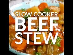 slow cooker beef stew with carrots and celery in a blue bowl