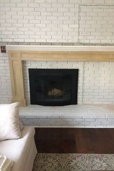 a living room with a white brick fireplace