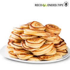 a pile of pancakes sitting on top of a white plate