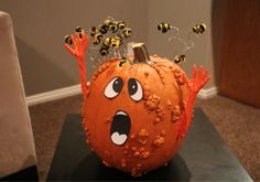 a carved pumpkin with bees on it's head