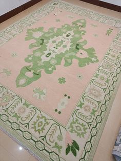 a pink and green rug on the floor