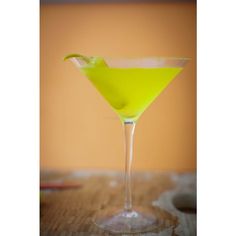 a yellow drink sitting on top of a wooden table