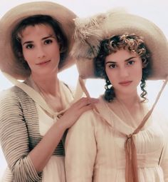 two women in hats pose for the camera