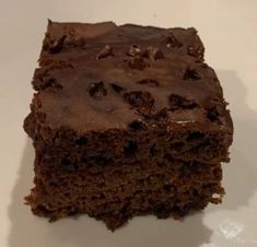 a piece of chocolate cake sitting on top of a white plate