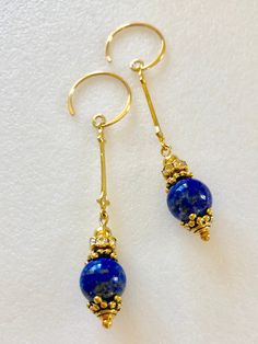 "Rich Blue lapis lazuli gemstones dangle from 18k gold vermeil Art Deco wands with antique gold bead cap and rhinestone accents. Beautiful 10mm high quality lapis lazuli gems are wire wrapped onto 18k gold vermeil over .925 Sterling silver Art Deco connectors accented with Czech glass rhinestones and antique gold pewter bead caps by Tierracast. Made in USA. Earrings hang from handmade 24k gold vermeil open hoops. Total drop is 2 3/8\"." Usa Earrings, Black Cat Earrings, Art Deco Gold, Gemstone Art, Lapis Lazuli Earrings, Jewelry Making Earrings, Pumpkin Earrings, Fall Earrings, Blue Lapis