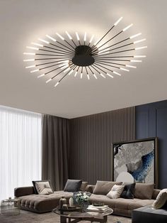 a living room with couches, tables and lamps on the ceiling above it is a circular chandelier