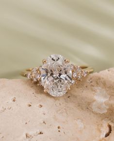 a diamond ring sitting on top of a rock