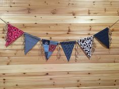 several different colored pennants hanging on a wooden wall