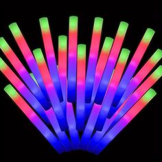 neon glow sticks are in the dark with black background