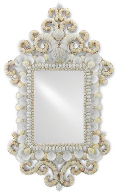 a mirror that has shells on it and is hanging from the wall with an ornate frame