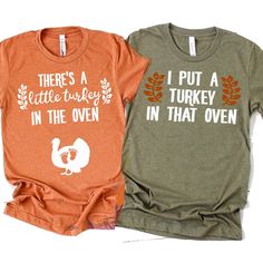 Celebrate Thanksgiving in style with these adorable Couples Thanksgiving Pregnancy Announcement Shirts! Perfect for announcing your exciting news, these matching shirts feature the fun message I Put A Turkey In That Oven There's A Little Turkey making them a hilarious way to reveal your pregnancy. These shirts are the perfect addition to your fall wardrobe and are sure to bring smiles to everyone's faces. Get ready to share the joy of your upcoming arrival with these unique and funny t-shirts! + Thanksgiving Cotton T-shirt With Crew Neck, Cotton Crew Neck T-shirt For Thanksgiving, Thanksgiving Cotton T-shirt With Letter Print, Thanksgiving Letter Print Cotton Tops, Couples Thanksgiving, Thanksgiving Pregnancy Announcement, Pregnancy Announcement Shirt, Baby Reveal, Fall Baby