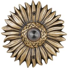 a gold sunflower door knocker on a white background