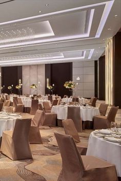 a banquet room set up with tables and chairs