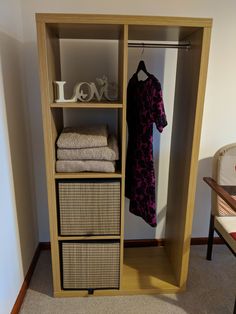 an open closet with clothes hanging on it