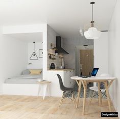 a small kitchen and dining area with wood floors, white walls and wooden flooring