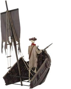 a figurine is sitting on top of a boat with a pirate's flag