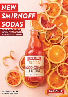 a bottle of soda surrounded by sliced oranges on a pink background with the words, new smirnoff sodas