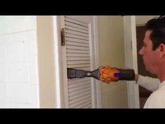 a man using an electric drill to fix a door