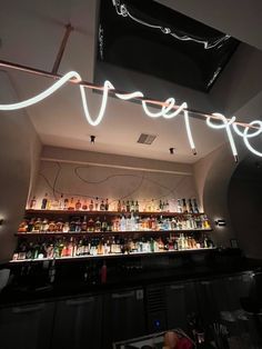 an open bar with neon lights above it