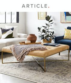 a living room scene with focus on the couch and coffee table in the foreground