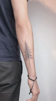 a man with a tree tattoo on his arm