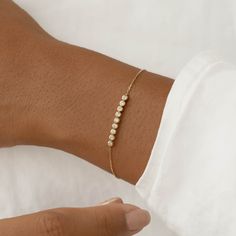 The Maelie Bracelet features a row of 9 bezel-set diamonds on a dainty 14k yellow gold chain. 

Versatile and elegant, this bracelet will elevate any look.


9 lab grown diamonds, each with a width of 2mm 

Total carat weight: 0.27 

14k yellow gold 


Bracelet can be worn between 5.75” and 7” (fitting wrists with circumference ~5.25” to 6.75”) Ring Redesign, Fine Bracelet, Dainty Gold Bracelet, Cute Engagement Rings, Diamond Necklace Designs, Silver Jewelry Design, Bezel Set Diamond, Diamond Settings, Dainty Bracelets