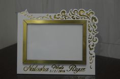 a white and gold photo frame on a table