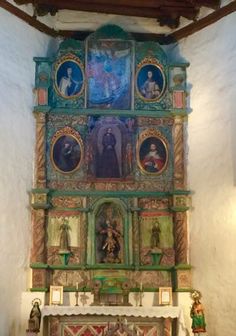 an old church altar with paintings on the wall