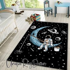 an area rug with an astronaut sitting on the moon holding a paintbrush and bucket