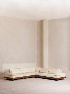 a large white couch sitting in the middle of a room