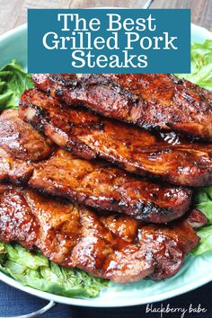 the best grilled pork steaks on a plate with lettuce