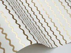 an image of a white and gold wallpaper with wavy lines on the back side