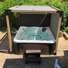 a hot tub sitting in the middle of a yard