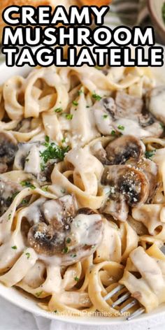 creamy mushroom tagliatelle in a white bowl with a fork