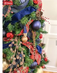 a christmas tree decorated with blue, red and gold ornaments is featured in this post