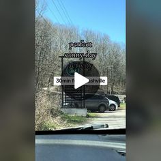 a car is parked in front of a sign that says perfect sunny day parking lot