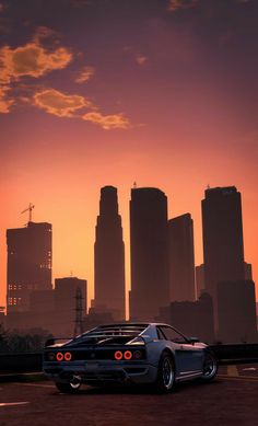 a car is parked in front of a city skyline at sunset with the sun going down