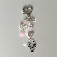 a keychain with a cartoon character on it and hearts attached to the chain