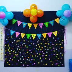 balloons and streamers are hanging on the wall above a birthday party banner with confetti