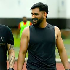 two men with tattoos on their arms walking together