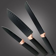 three knives with black handles and rose gold accents