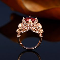 The powerful Lion represents unrivaled courage and strength. Crafted in sterling silver, this ring features a round cut center stone warpped by two lively lions, while additional stones adorn the ring to add more sparkles. The red stone set on the center of the ring adds a sense of mystery to this ring. As a strong and brave figure, you will be ready to take on any challenge when you wear this ring.Carat Weight: 6.46 ctStone Size: 10 mmStone Type: Jeulia® StoneNumber of Stones: 1 Stone Shape: RoundStone Color: Garnet RedCarat Weight: 1.66 ctStone Size: 1,1.2,0.8 mmStone Type: Jeulia® StoneNumber of Stones: 200 Stone Shape: RoundStone Color: Diamond WhiteWeight: 9 gWidth: 4.6 mmHeight: 13 mmThickness: 1.6 mmMaterial: 925 SilverPlating Color: Rose Gold Lion Ring Gold, Magic Academy, Lion Ring, Garnet Rings, Red Stone, Stone Settings, Sterling Silver Ring, Hogwarts, Women Rings