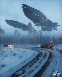 a car driving down a snow covered road next to tall buildings in the distance with flying objects above them